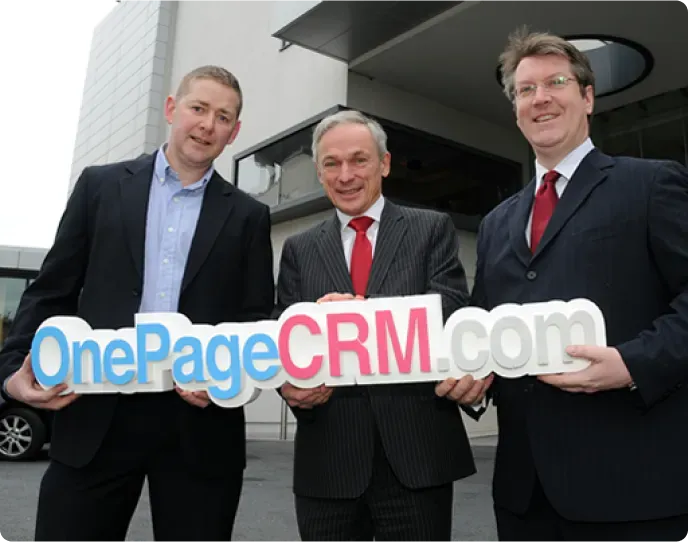 Michael FitzGerald and colleagues holding a OnePageCRM.com sign at the Enterprise Ireland funding announcement