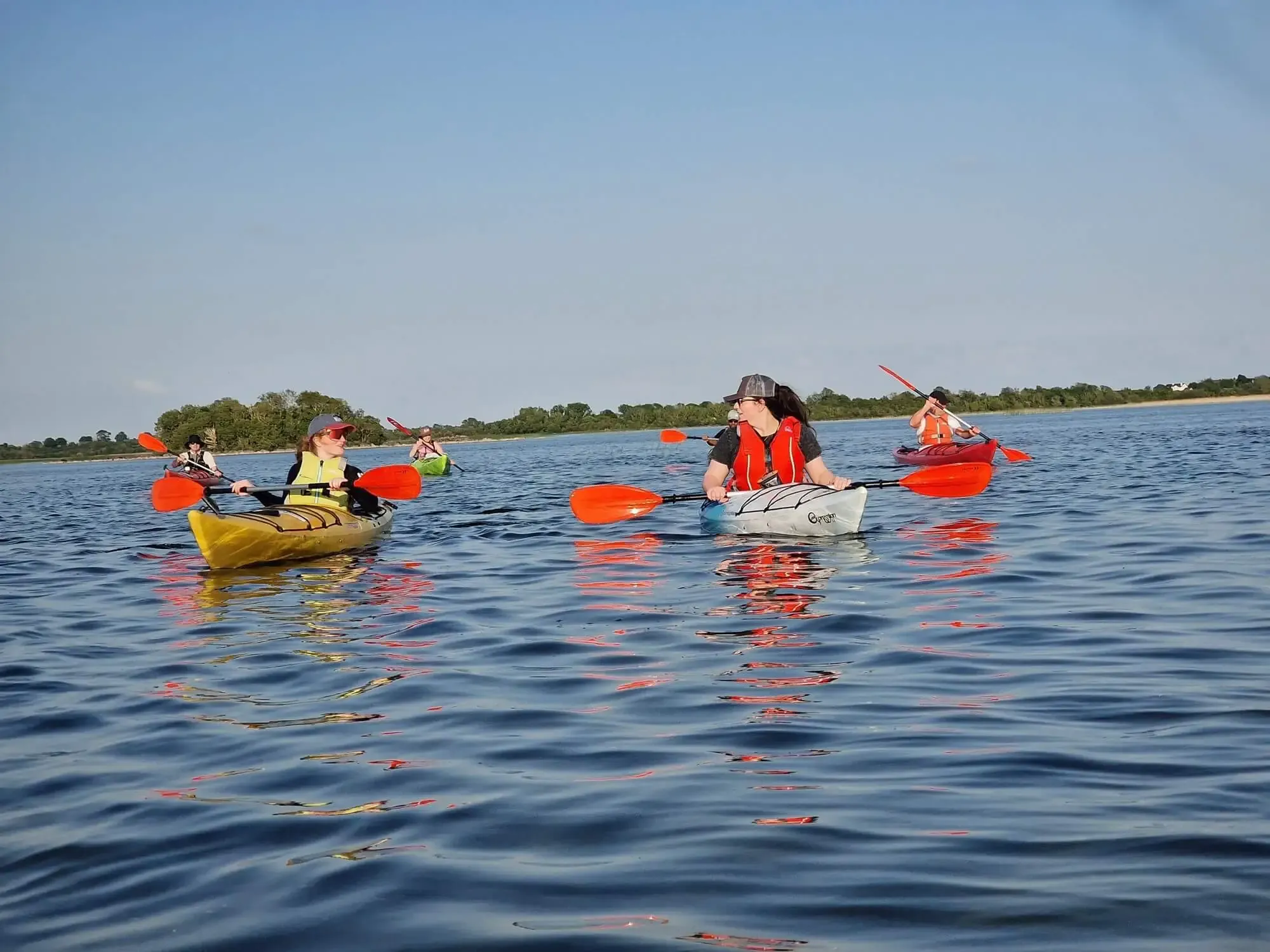 Members of the team kayaking together on the water near Galway