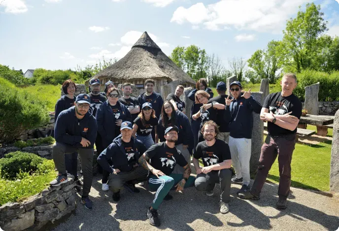 The whole OnePageCRM team outdoors in matching shirts at a company Gathering in Ireland