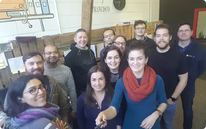 The early OnePageCRM team squeezed into a selfie in the pallet-walled Galway office